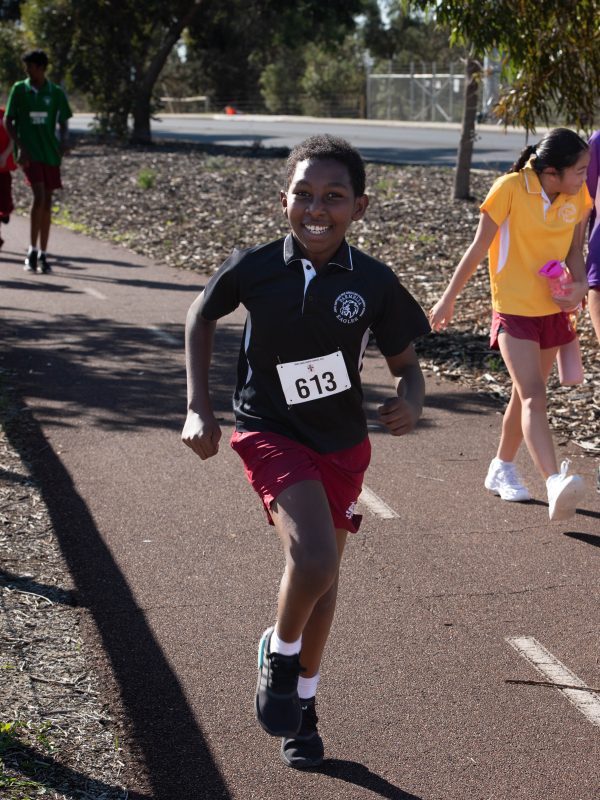 Cross Country young student running and happy